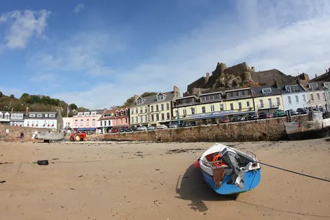 A fishing boat in Gorey harbour with Mont Orgueil Castle behind it
