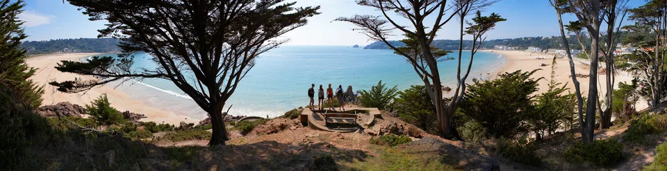 A tree-framed panorama across St Brelade’s Bay in Jersey