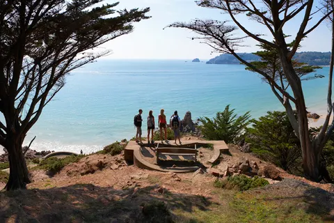 A tree-framed panorama across St Brelade’s Bay in Jersey