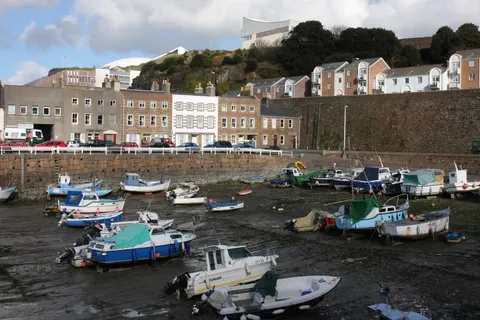 Boats in English Harbour in St Helier, Jersey, at low tide
